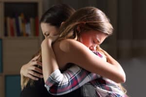 Mom hugs her teenager supportively during MAT